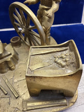 Load image into Gallery viewer, Vintage Brass Sculpture of a Blacksmith with A Wagon Wheel